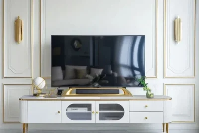 Elegant TV console with golden accents and a sleek design.