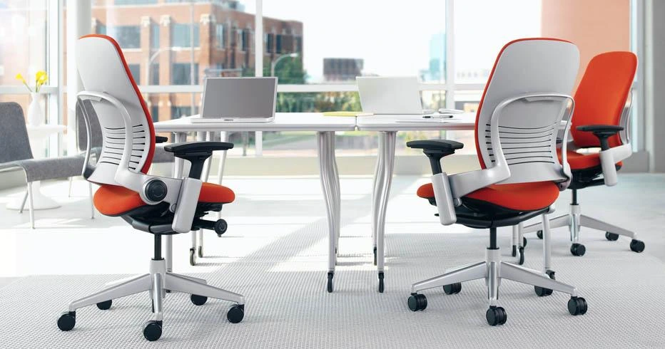 Modern used office table setup with storage cabinets and ergonomic chairs.